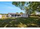 Expansive backyard showcasing shade trees, a utility shed, and fence for privacy at 188 Citrus Dr, Kissimmee, FL 34743