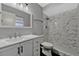 Updated bathroom featuring a modern vanity, undermount sink, and tiled shower with a rainfall showerhead at 188 Citrus Dr, Kissimmee, FL 34743