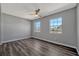 A brightly-lit bedroom features gray walls, light trim, and dark wood-look flooring at 188 Citrus Dr, Kissimmee, FL 34743