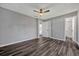 Spacious bedroom features wood flooring, a ceiling fan, and attached bathroom at 188 Citrus Dr, Kissimmee, FL 34743