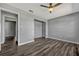 A large bedroom with dark wood flooring is open with a double closet at 188 Citrus Dr, Kissimmee, FL 34743