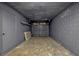 Spacious garage featuring an automatic door, block wall and painted floor at 188 Citrus Dr, Kissimmee, FL 34743