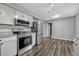Updated kitchen featuring stainless steel appliances, granite countertops, and wood-look vinyl flooring at 188 Citrus Dr, Kissimmee, FL 34743