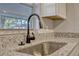 Close up on a kitchen sink with granite countertops and a modern faucet at 188 Citrus Dr, Kissimmee, FL 34743