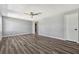 Open-concept living room boasts a ceiling fan, and dark hardwood flooring at 188 Citrus Dr, Kissimmee, FL 34743