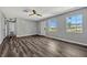 Bright living room with ceiling fan, wood-look flooring and natural light from two windows at 188 Citrus Dr, Kissimmee, FL 34743