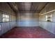 View of the interior of the shed with horizontal aluminum siding and two small windows at 188 Citrus Dr, Kissimmee, FL 34743
