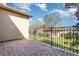 Brick paved patio and black metal fence overlooks a well-manicured lawn at 201 Walter Stevens Way, Deland, FL 32724