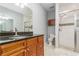 Bathroom with vanity, granite countertop, glass-enclosed shower, and tile floors at 201 Walter Stevens Way, Deland, FL 32724