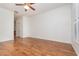 Bright bedroom with wood floors and ceiling fan offers ample space and natural light at 201 Walter Stevens Way, Deland, FL 32724