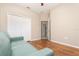 Bedroom with wood floors, double closet, and access to another room, providing flexibility at 201 Walter Stevens Way, Deland, FL 32724