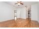 Spacious bedroom features wood floors, ceiling fan, and access to bathroom and other rooms at 201 Walter Stevens Way, Deland, FL 32724
