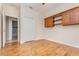 Bedroom with laminate wood flooring, built-in shelves and cabinets, and a closet at 201 Walter Stevens Way, Deland, FL 32724