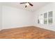 Bright bedroom with wood floors, ceiling fan, and large window provides ample natural light at 201 Walter Stevens Way, Deland, FL 32724