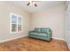 Cozy bedroom with wood floors, ample natural light, and a comfortable couch at 201 Walter Stevens Way, Deland, FL 32724