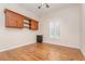 Bedroom with laminate wood flooring, built-in shelves and cabinets, and a bright window at 201 Walter Stevens Way, Deland, FL 32724