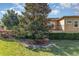 View of the home's exterior featuring a manicured lawn and black metal fence at 201 Walter Stevens Way, Deland, FL 32724
