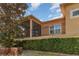 View of the home's exterior featuring a screened in porch and black metal fence at 201 Walter Stevens Way, Deland, FL 32724