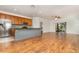 Kitchen with stainless steel appliances, wood cabinets, granite countertops, and an island at 201 Walter Stevens Way, Deland, FL 32724