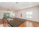 Kitchen island with granite countertops, a stainless steel sink, and wood cabinets at 201 Walter Stevens Way, Deland, FL 32724