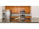 Modern kitchen with stainless steel appliances, wood cabinets, and granite countertops at 201 Walter Stevens Way, Deland, FL 32724