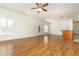 Open-concept living room featuring wood floors, lots of light, and a ceiling fan at 201 Walter Stevens Way, Deland, FL 32724