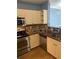 Kitchen featuring stainless steel appliances, stone countertops, and ample cabinetry at 204 E South St # 5057, Orlando, FL 32801