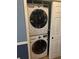 Laundry area equipped with a stacked washer and dryer unit at 204 E South St # 5057, Orlando, FL 32801