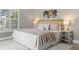 Inviting bedroom with light-toned walls, hardwood floors, and bright light from a window at 2527 Mohawk Trl, Maitland, FL 32751