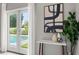 Bright bedroom showcasing French doors with pool view, a modern side table, and neutral decor at 2527 Mohawk Trl, Maitland, FL 32751