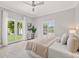 Bright bedroom with French doors leading to the backyard, light wood floors, and modern finishes at 2527 Mohawk Trl, Maitland, FL 32751