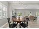 Dining area featuring round wood table, views of the pool and access to open-concept living at 2527 Mohawk Trl, Maitland, FL 32751