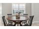 Charming dining nook with wood table, seating for four, and a view of a shuttered window at 2527 Mohawk Trl, Maitland, FL 32751