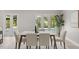 Bright dining room with marble table, seating for six, and a view of the backyard landscaping through glass doors at 2527 Mohawk Trl, Maitland, FL 32751