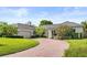 Elegant home featuring brick driveway, well-maintained lawn and manicured shrubbery at 2527 Mohawk Trl, Maitland, FL 32751