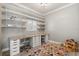 Spacious home office area with built-in desks, shelving, and a bright window at 2527 Mohawk Trl, Maitland, FL 32751