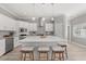 Bright kitchen with island, stainless steel appliances, pendant lighting and hardwood floors at 2527 Mohawk Trl, Maitland, FL 32751