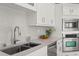 Close-up of a kitchen counter with stainless steel sink and appliances, and granite countertops at 2527 Mohawk Trl, Maitland, FL 32751