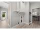 Laundry room area with built-in shelves, cabinets, and access to backyard at 2527 Mohawk Trl, Maitland, FL 32751