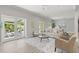 Bright living room with neutral tones, wood floors, and sliding glass doors to the backyard at 2527 Mohawk Trl, Maitland, FL 32751