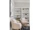 Inviting living room featuring two chairs, neutral decor, and custom built-in bookshelves at 2527 Mohawk Trl, Maitland, FL 32751