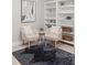 Relaxing living room featuring two chairs, custom built in shelving, and stylish decor at 2527 Mohawk Trl, Maitland, FL 32751