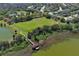 Community with a lake, a covered dock, and a vast green playing field at 2545 Azzurra Ln, Ocoee, FL 34761