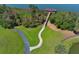 Picturesque walkway leading to a covered wooden dock over the serene lake waters at 2545 Azzurra Ln, Ocoee, FL 34761