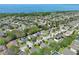 An aerial view of a neighborhood with a lake in the background, showcasing a community of single-Gathering homes at 2545 Azzurra Ln, Ocoee, FL 34761