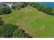 Expansive green community field with baseball diamond, soccer goal, and lakeside access at 2545 Azzurra Ln, Ocoee, FL 34761