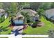 An aerial view showcasing a charming home with a manicured lawn and mature palm trees at 2545 Azzurra Ln, Ocoee, FL 34761