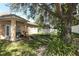 Lush backyard featuring mature trees and an outdoor swing, with the home's patio in the background at 2545 Azzurra Ln, Ocoee, FL 34761