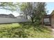 Large backyard with a white fence, mature trees, and an enclosed patio at 2545 Azzurra Ln, Ocoee, FL 34761