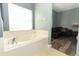 Bathroom featuring a large soaking tub next to the window at 2545 Azzurra Ln, Ocoee, FL 34761